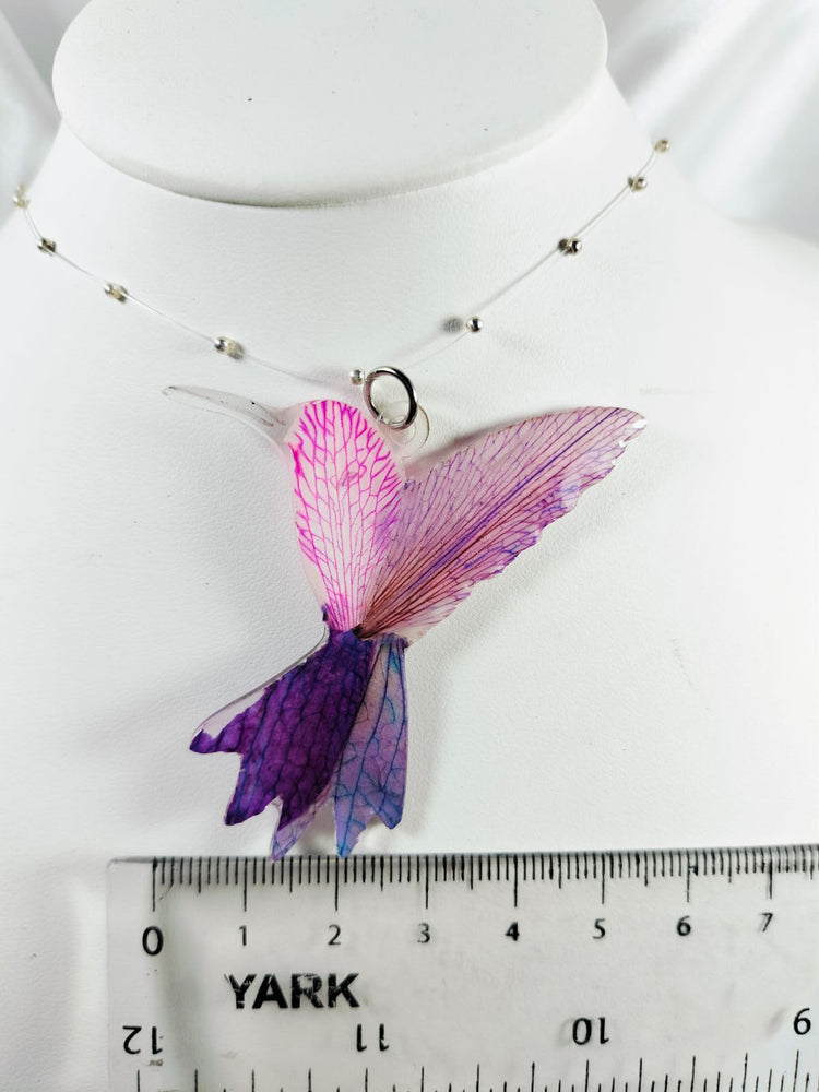 Dije de colibrí de pétalos de orquídea